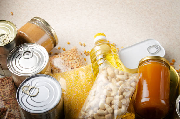 istock Flat lay view at kitchen table full with non-perishable foods. Spase for text 1253093568