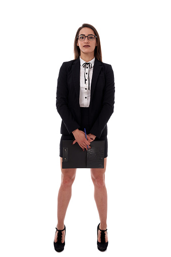 Full length of a businesswoman with clipboard over white background