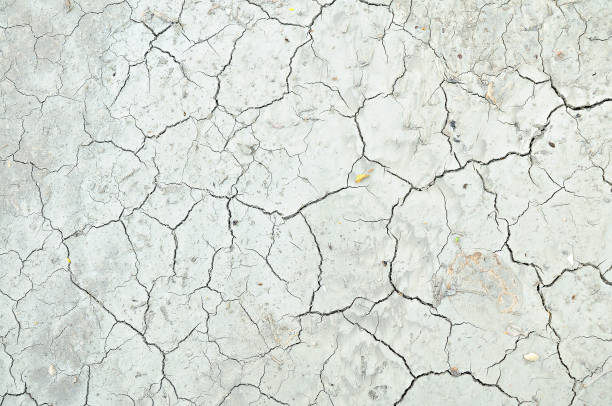 istock Cracks on the surface of gray clay/ Background 1253094519