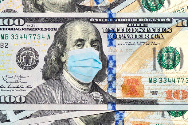 istock Hundred dollar bill with a medical mask on Franklin  face. 1253094804