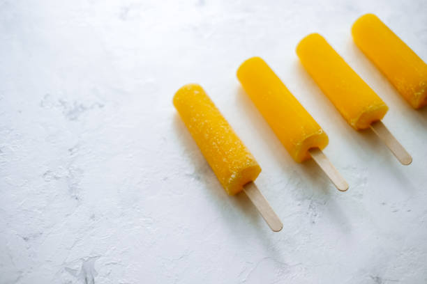 istock Orange fruit ice isolated on a white background. Stick ice cream. 1253097258