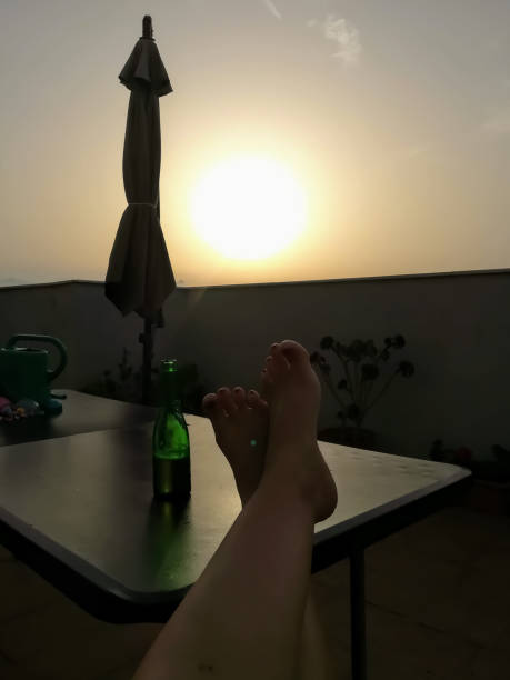 istock Enjoying a beer with feet on a terrace table 1253100048
