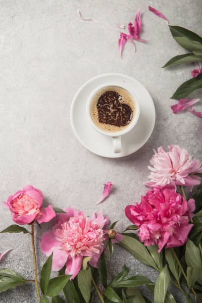 istock Note book, peonies and cup of coffee on light concrete backgrounds 1253104816