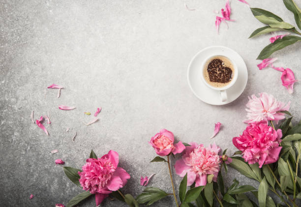 istock Note book, peonies and cup of coffee on light concrete backgrounds 1253104821