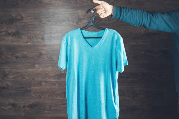 istock man hand hanger of shirt 1253108645