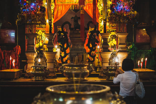 HongKong, China - November, 2019: Woman Inside old chinese temple (Man Mo Temple) in Hong Kong