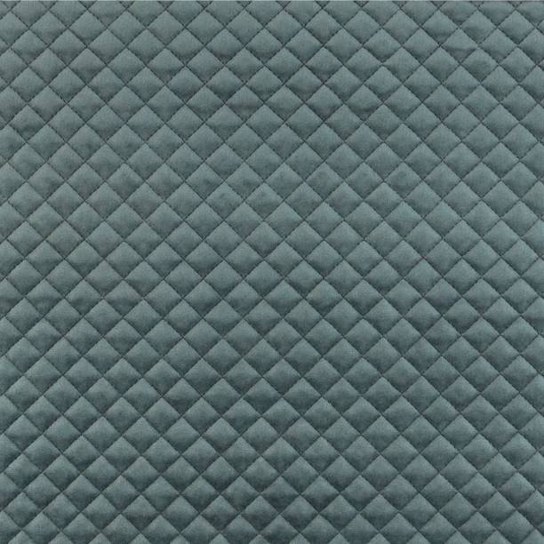 Velvet upholstery quilted fabric texture in charcoal grey