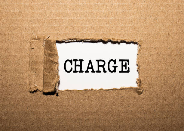istock The text CHARGE. behind torn brown paper 1253113660