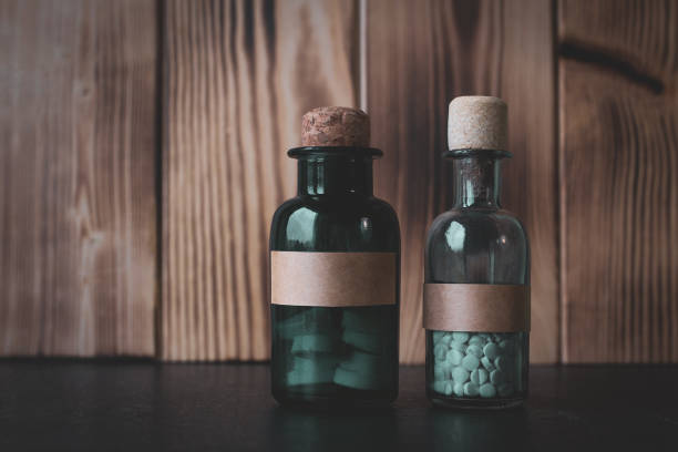 istock White drugs in glass bottles with a cork. 1253115033