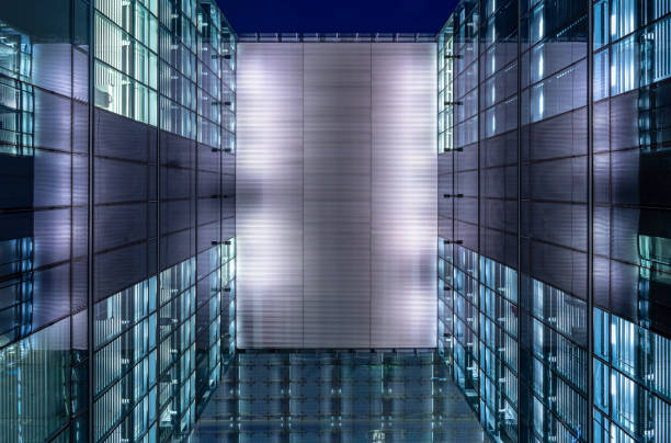 istock Modern Glass Building In City At Night 1253117932