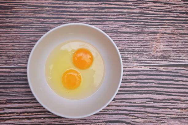 istock In selective focus top view of a fresh egg in a white bowlon old wooden table background with copy space 1253118529