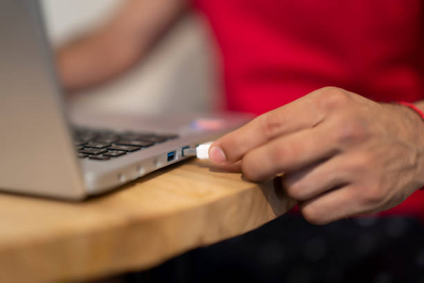 istock young man using the usb port of his laptop 1253120648