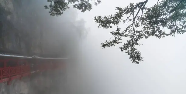 Photo of Path on a cliff of Tianmen mountain covered in fog