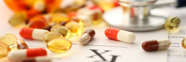 istock Pile of tablets lying over prescription application form 1253123287