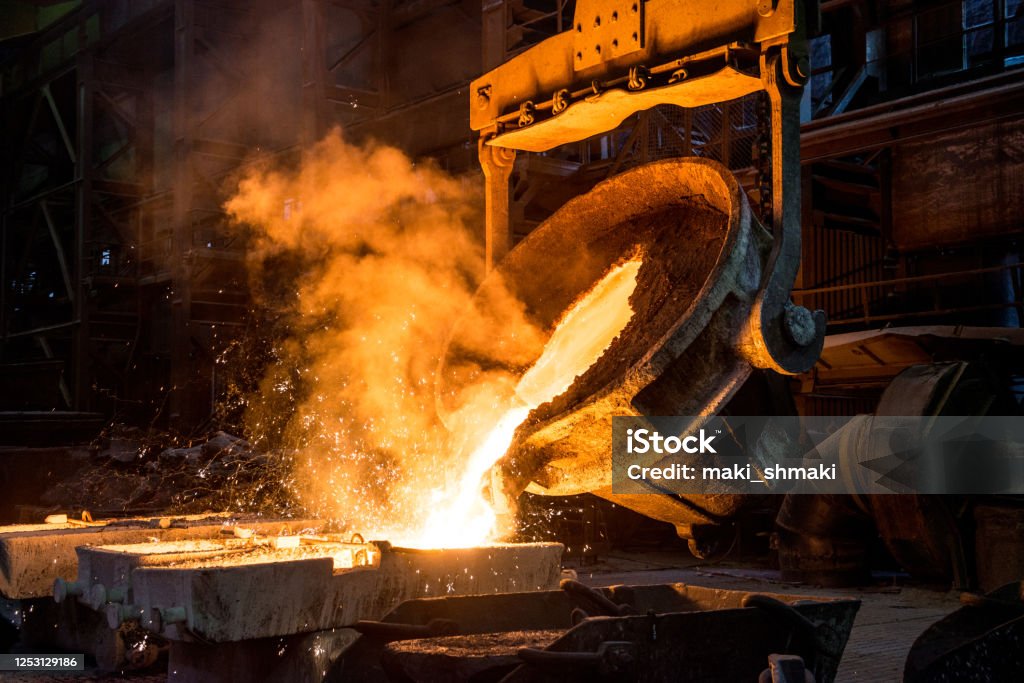 Tank pours liquid metal in the molds Foundry Stock Photo