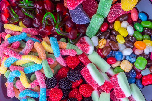 Assorted colorful gummy candies. Top view. Jelly donuts. Jelly bears. Isolated on a white background.