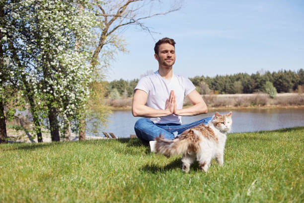 istock Restful young male doing yoga exercises in nature 1253129587