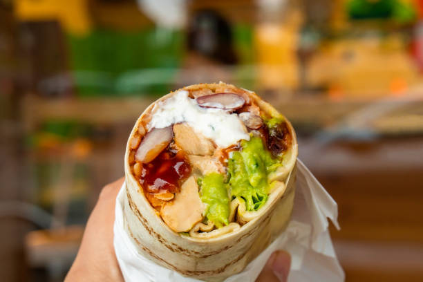 istock Mexican traditional authentic homemade Burrito with pulled pork beef chili con carne served with tomato salad and avocado guacamole and dip sauce 1253130429