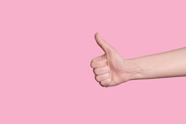 istock Thumb up close up, recommendation about a good choice, successful work. 1253134465