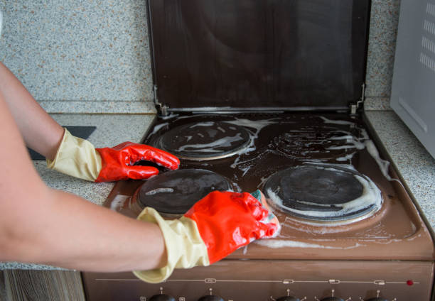 istock Process of cleaning dirty electrical stove 1253135019