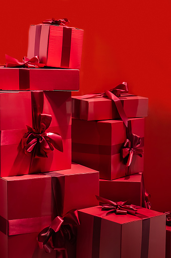 Large gift boxes with a bow on a red background.