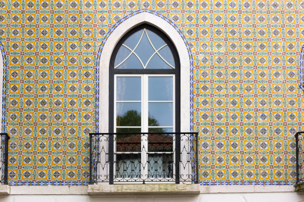 Small balcony with tall window doors and traditional tiles wall building in Lisbon, Portugal