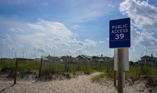 A sign on a sandy beach stating \