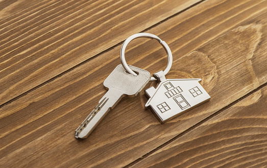 House Key And Key chain On Wooden Table