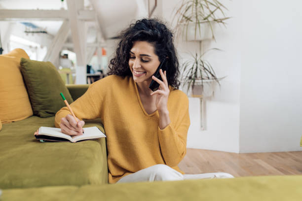 istock Young manager having a business call during at home 1253150822