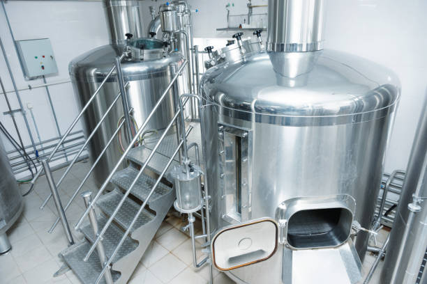 Two mash-tubs on beer-making plant, toned Two mash vats used to mix and boil malt, beer-making plant, toned mixing vat stock pictures, royalty-free photos & images