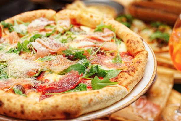 istock Pizza with prosciutto ham and parmesan, toned 1253153575