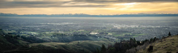 istock Panoramic sunset shot of city with mountains backdrop 1253160522