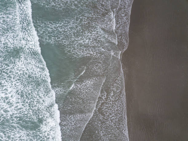istock Waves and beach aerial shot from bird eye view 1253161571