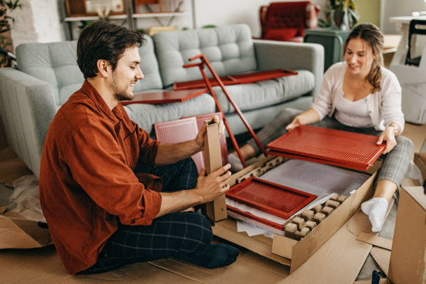 istock Couple assembling furniture at home 1253162837
