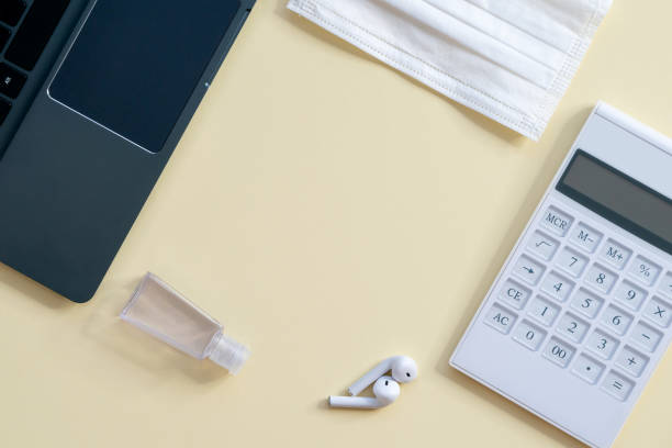 istock Work at home, home office with laptop, mask, sanitizer and calculator 1253166801