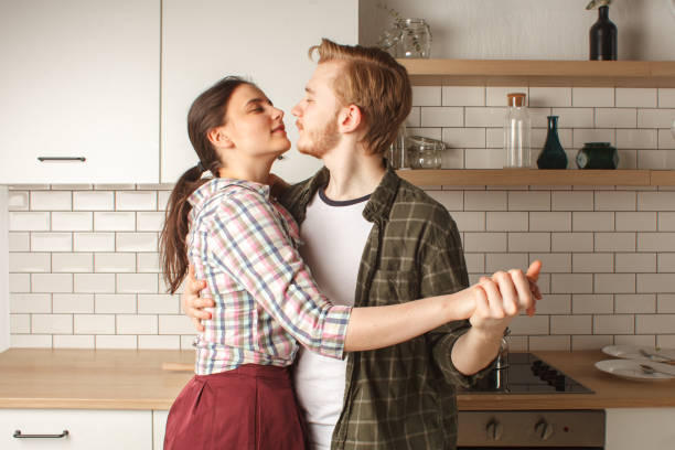 istock young couple on quarantine dancing on kitchen at home 1253171576