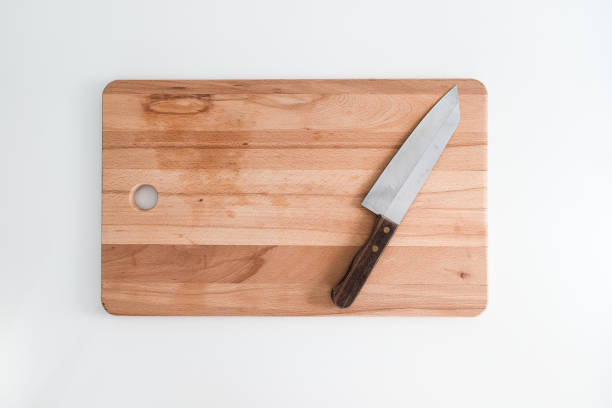 istock Knife on cutting board isolated on white kitchen background 1253174617