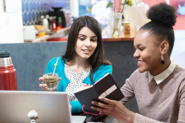 Multiracial group of young people working and drinking mate at bar