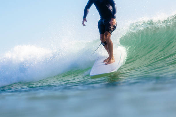 istock A man is surfing a wave on a surfboard at Noosa Heads 1253176674