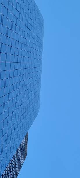 istock Clear blue sky with tall glace buildings 1253178811