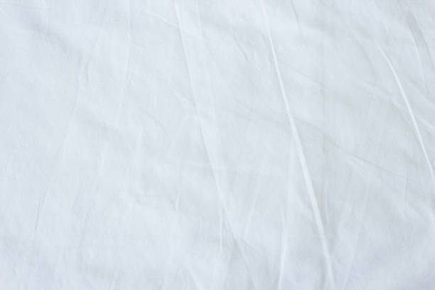 istock Top view of white fabric bed sheet texture background. 1253180705