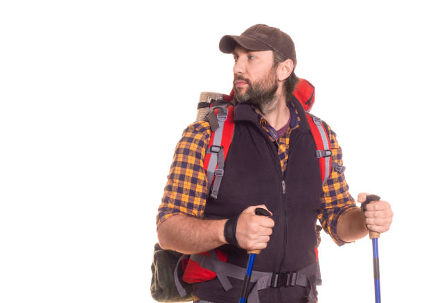 Handsome middle aged traveler with backpack looking by side - isolated on white. Active lifestyle concept.