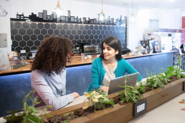 istock Multiracial young women having breakfast and working in a bar 1253182333