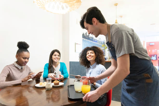 istock Multiracial young women being served breakfast at the bar 1253183042