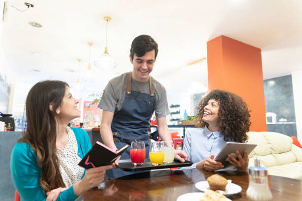 istock Multiracial young women being served breakfast at the bar 1253183191
