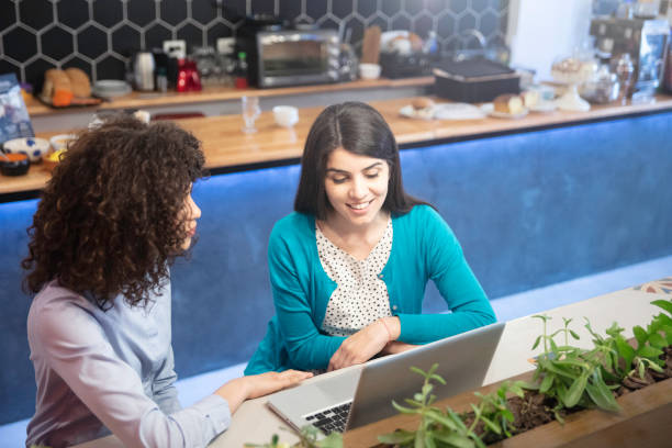 istock Multiracial young women having breakfast and working in a bar 1253183308