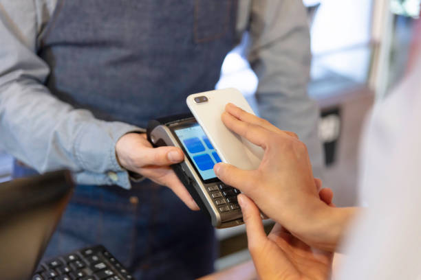 istock Female customer paying to bar's owner 1253186469