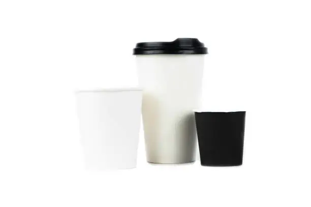 A row of paper coffee cups on a white background.Glasses for coffee and tea of different sizes isolated on white background. Hot coffee, starbucks