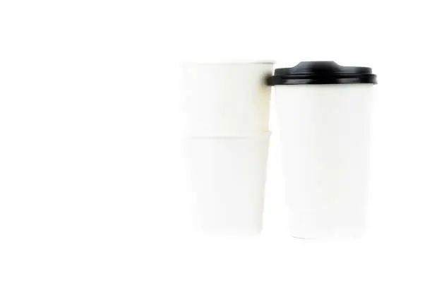 Photo of A row of paper coffee cups on a white background.Glasses for coffee and tea of different sizes isolated on white background. Hot coffee, starbucks.