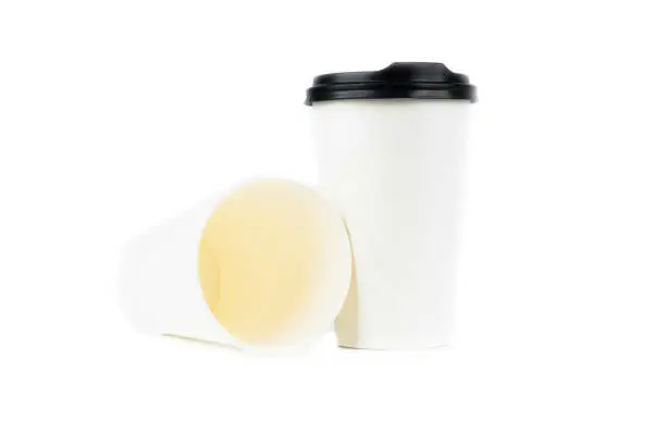 Photo of A row of paper coffee cups on a white background.Glasses for coffee and tea of different sizes isolated on white background. Hot coffee, starbucks.